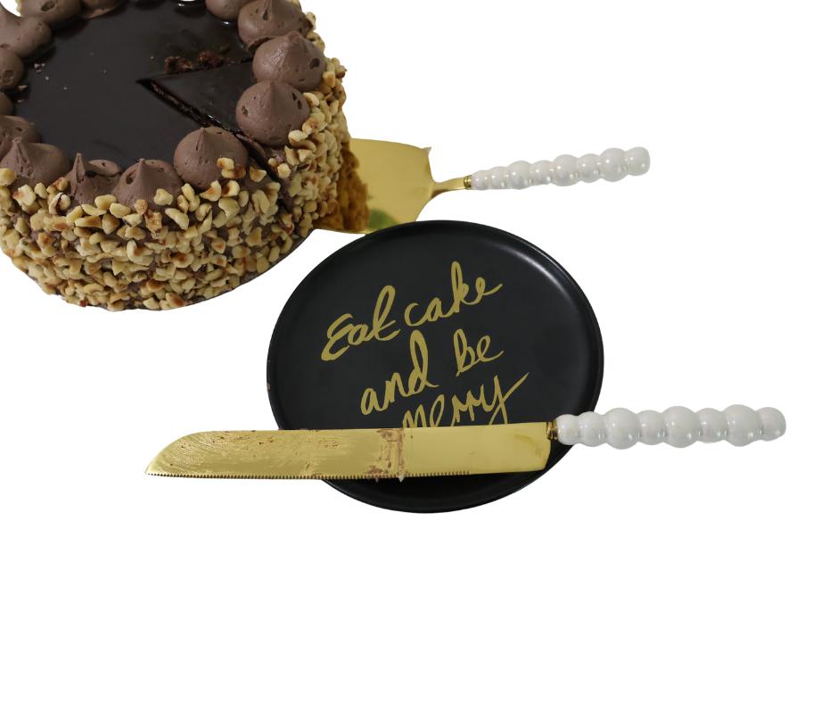 Decorative cake server with a pearl handle and gold blade, featuring the text 'Eat cake and be merry'.