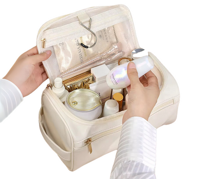White cosmetic bag with skincare products being held by a person