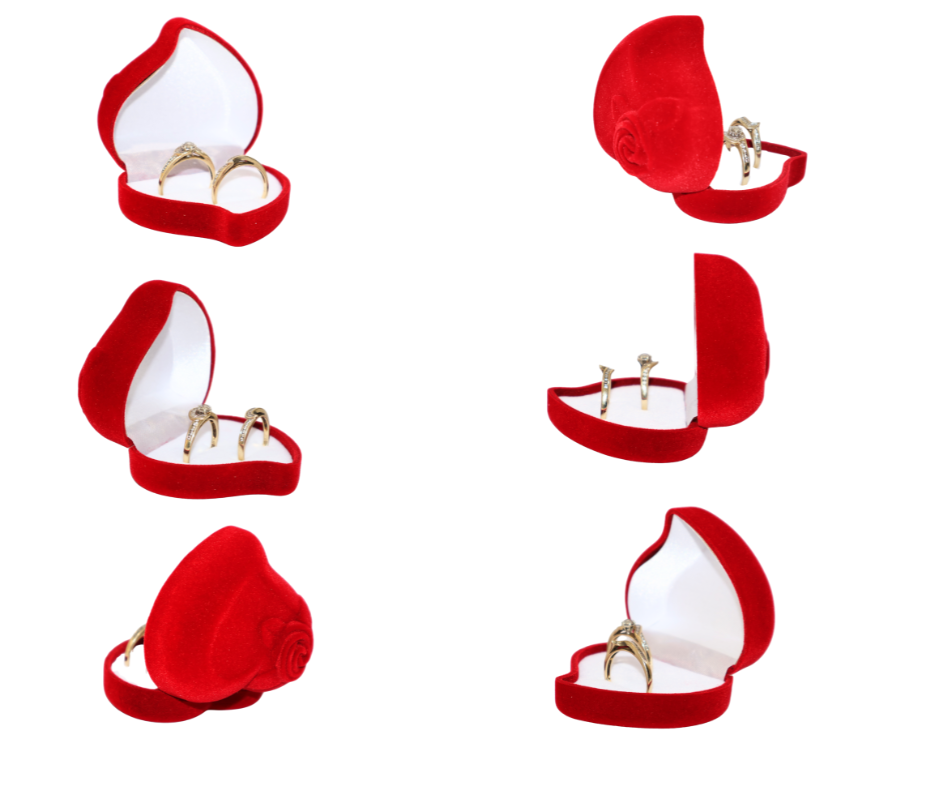 Red velvet heart shaped double ring box with a gold ring on a white background