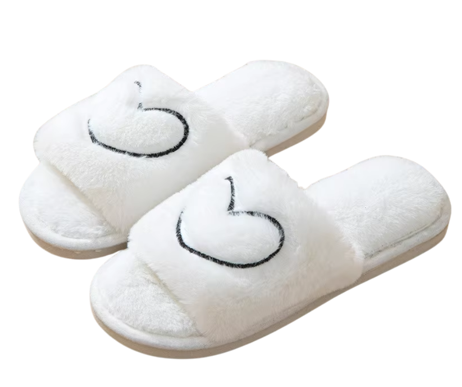 White slippers with heart design on a white background