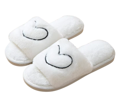 White slippers with heart design on a white background