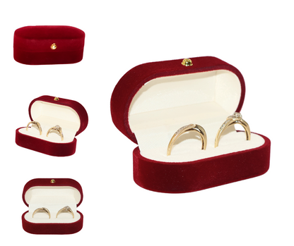 Red velvet double ring box with gold rings on a white background