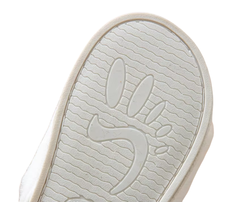 Close-up of a white shoe sole with a brand logo on a white background