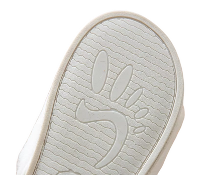 Close-up of a white shoe sole with a brand logo on a white background