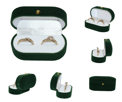 Green velvet double ring box with gold rings on a white background