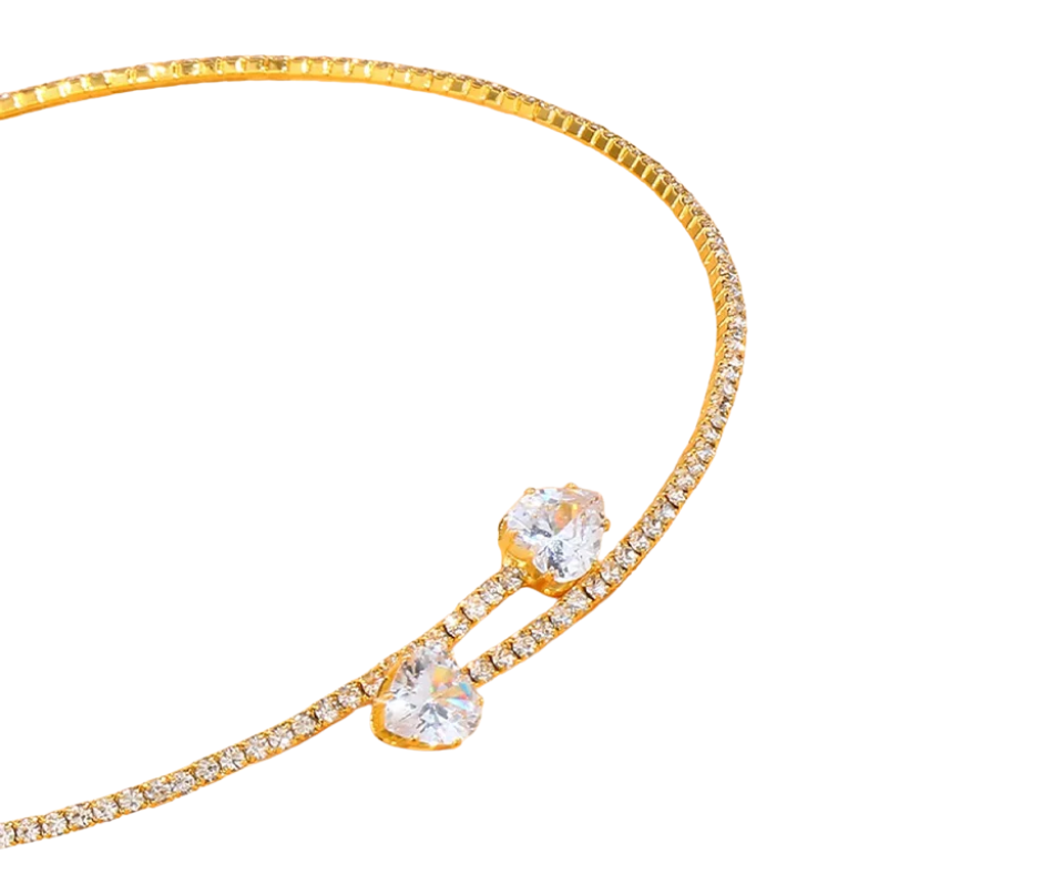 Gold chocker with clear heart gemstones on a white background