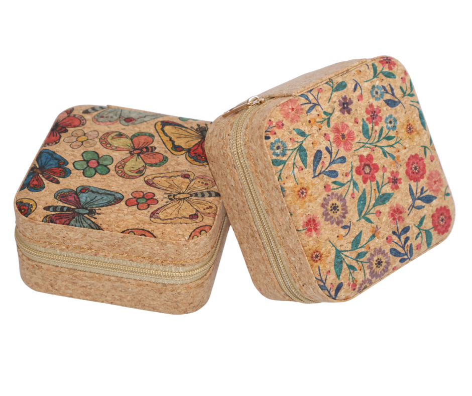 Two cork jewelry cases with butterfly and floral patterns on a white background