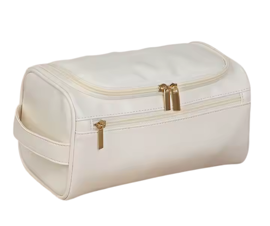 White toiletry bag with gold zippers on a white background