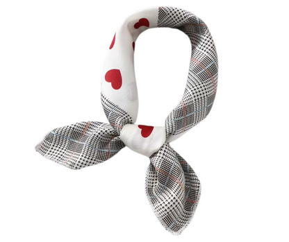 White scarf with red hearts and black checkered pattern on a white background