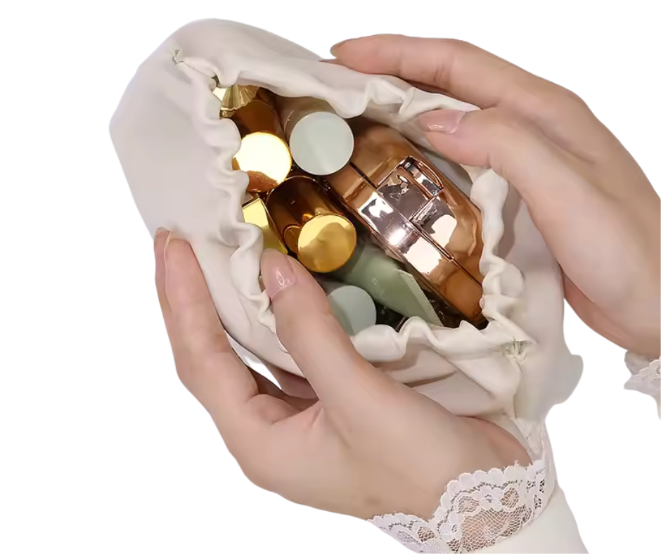 Hands holding a small white bag with perfume bottles inside on a white background