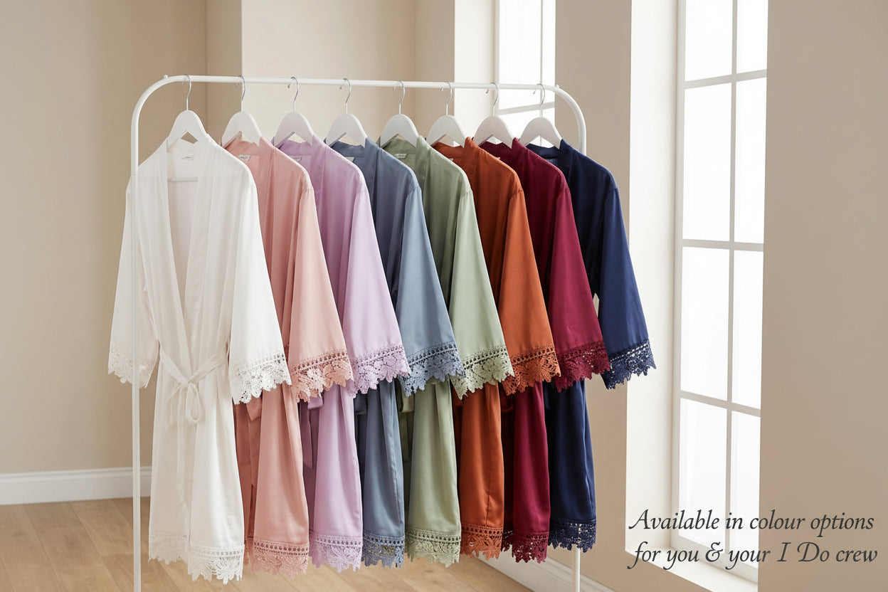 Set of colorful bridesmaid robes on a clothing rack in a room with a window.